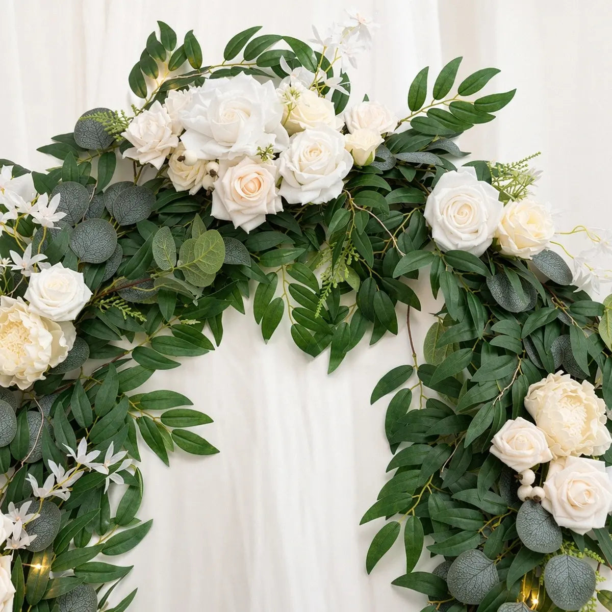 Artificial white rose eucalyptus garland shaped as wreath on round arch with warm LED lights and dense green willow leaf foliage – IPOPU
