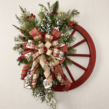 Farmhouse wooden wagon wheel Christmas wreath with snowflake and berries displayed on a neutral wall for indoor home decor