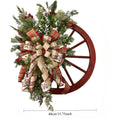 Green farmhouse wagon wheel Christmas wreath with ribbon bow berry accents front door decor
