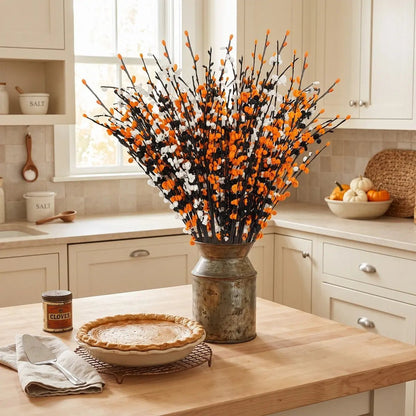 10 Halloween artificial jasmine flower stems in orange, white and black arranged in a dark vase as a spooky Halloween centerpiece on a styled table