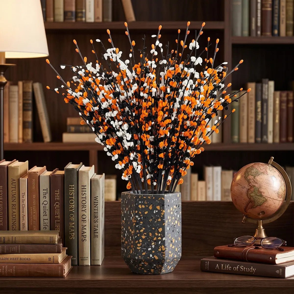 Close-up detail of orange, white and black artificial jasmine blooms from the Halloween floral picks set showing petal texture and stem construction