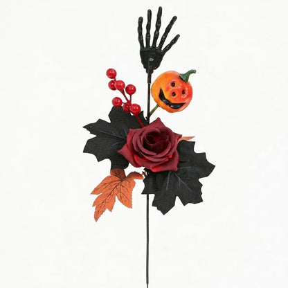 Halloween skeleton hand flower stem with pumpkin ghost face and dark floral arrangement