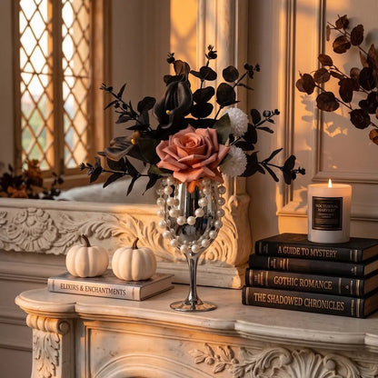 Gothic artificial flower arrangement in silver goblet vase displayed in a dark moody room with candles and Halloween decor