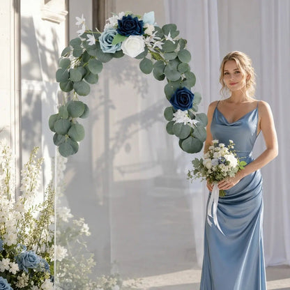Navy blue dusty blue rose silver dollar eucalyptus swag set of 2 styled on clear acrylic round wedding arch with bridesmaid in dusty blue gown holding bouquet indoors – IPOPU