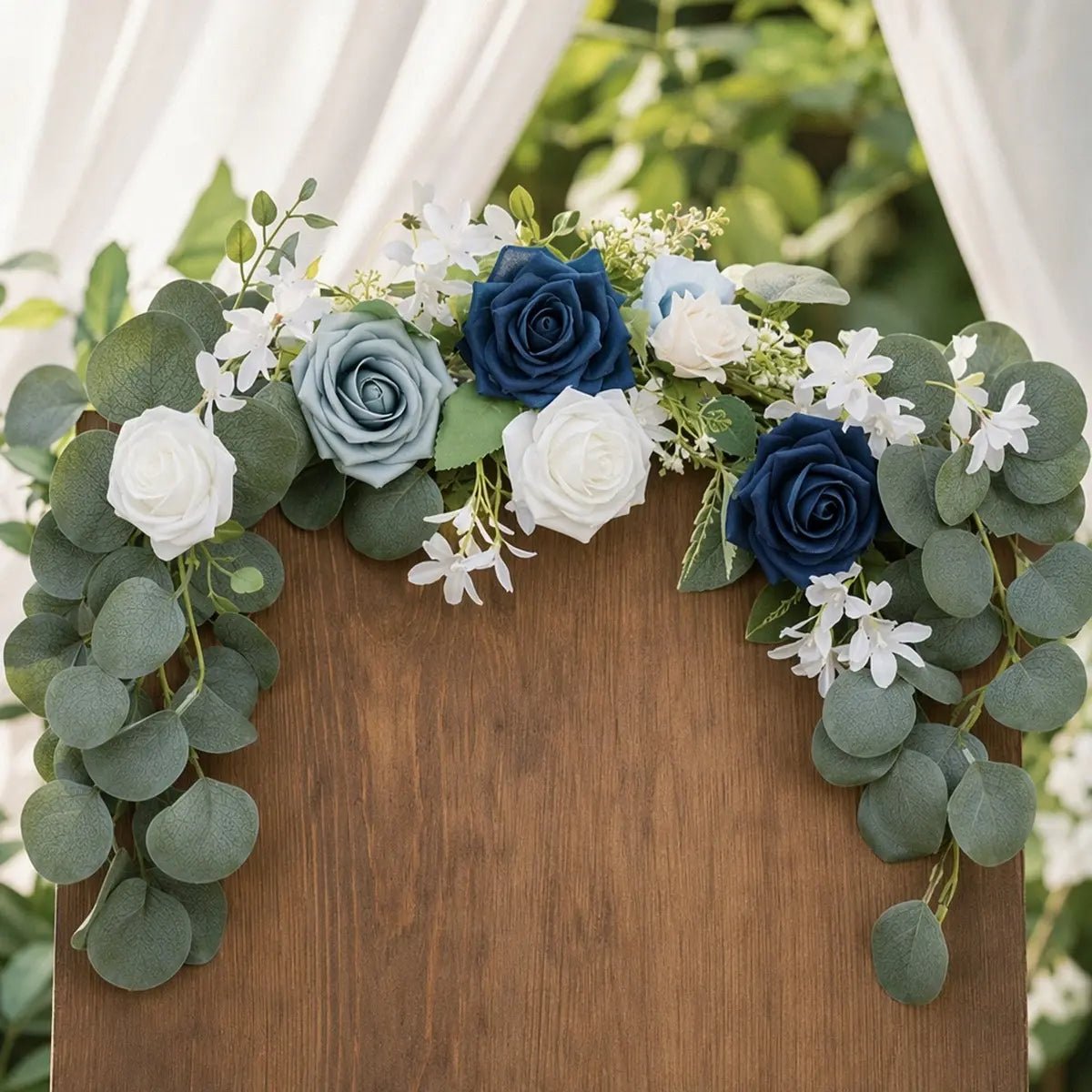 Navy blue dusty blue white rose silver dollar eucalyptus chair swag set of 2 draped across rustic wood arch top at outdoor garden wedding with white chiffon backdrop – IPOPU