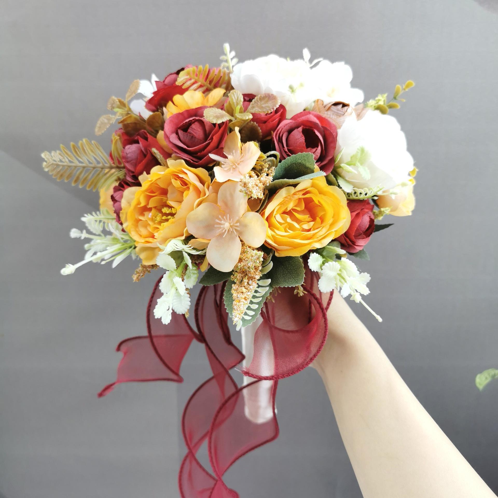 Orange artificial wedding bouquet with roses and hydrangeas for bridal decor