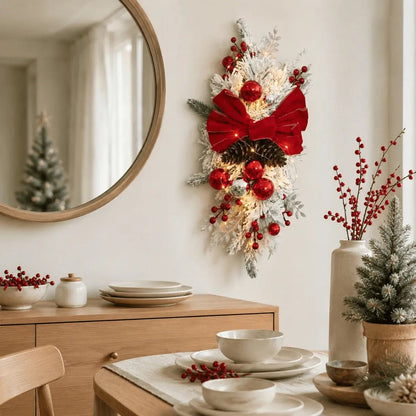 Red bow flocked Christmas teardrop swags displayed on double doors