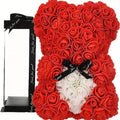 Red rose teddy bear with black ribbon in colorblock gift box

