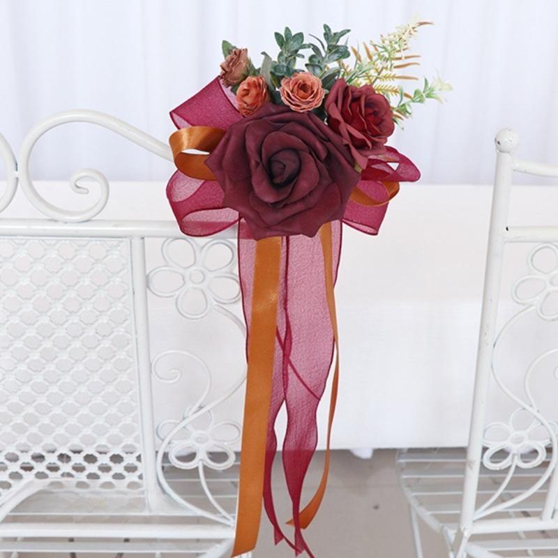 Red artificial flower pew decoration with eucalyptus and ribbon wedding aisle decor