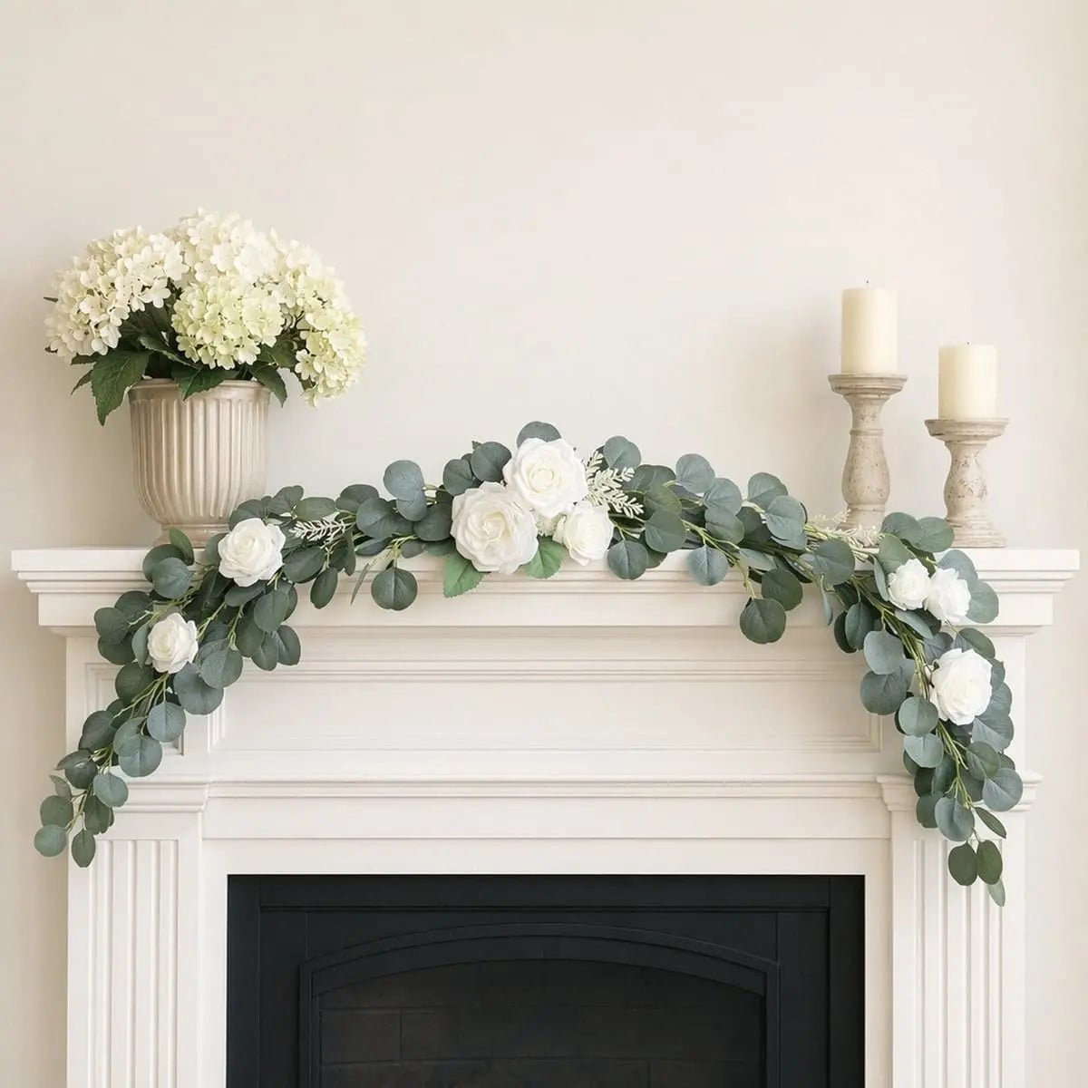 White rose silver dollar eucalyptus swag set of 2 laid end to end as mantel garland on white fireplace with ivory candle holders and hydrangea vase – IPOPU