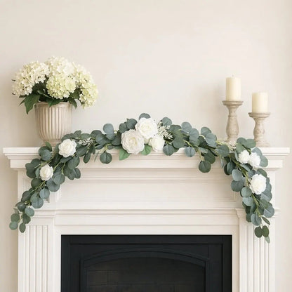 White rose silver dollar eucalyptus swag set of 2 laid end to end as mantel garland on white fireplace with ivory candle holders and hydrangea vase – IPOPU
