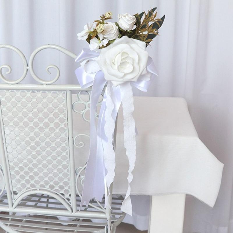 White artificial flower pew decoration with eucalyptus and ribbon wedding aisle decor