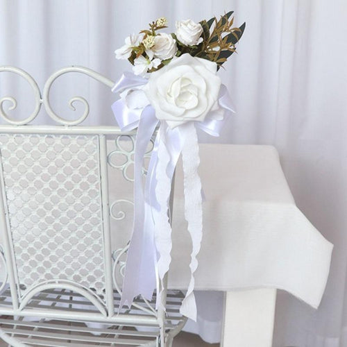 White artificial flower pew decoration with eucalyptus and ribbon wedding aisle decor